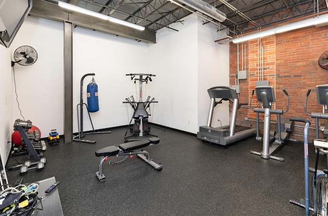 301 E Court Ave Unit 203, Des Moines, IA 50309 - gym with a towering ceiling and brick wall