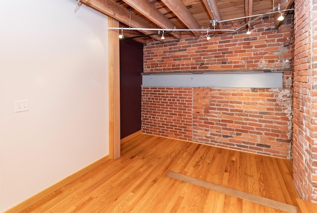 301 E Court Ave Unit 203, Des Moines, IA 50309 - basement featuring wood finished floors and brick wall