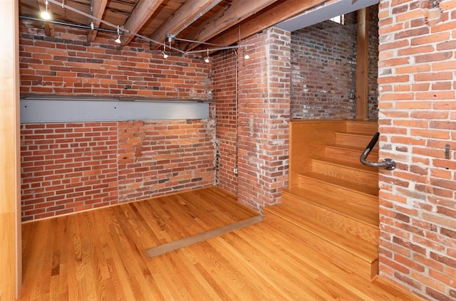 301 E Court Ave Unit 203, Des Moines, IA 50309 - finished below grade area featuring brick wall and wood finished floors