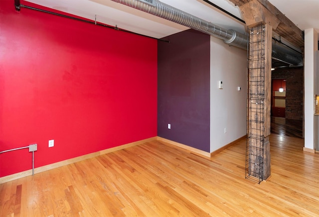301 E Court Ave Unit 203, Des Moines, IA 50309 - unfurnished room featuring wood finished floors and baseboards
