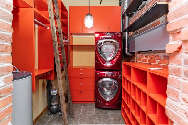 301 E Court Ave Unit 203, Des Moines, IA 50309 - washroom featuring stacked washing machine and dryer, water heater, and tile patterned flooring