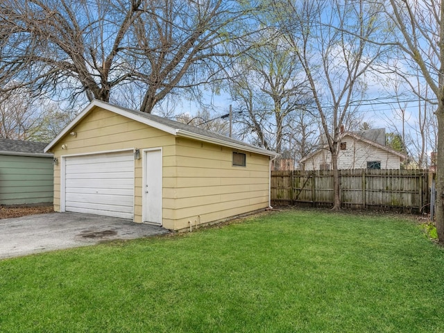 detached garage with driveway and fence