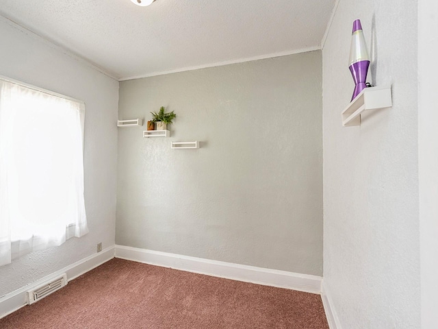 spare room with a healthy amount of sunlight, baseboards, carpet, and visible vents