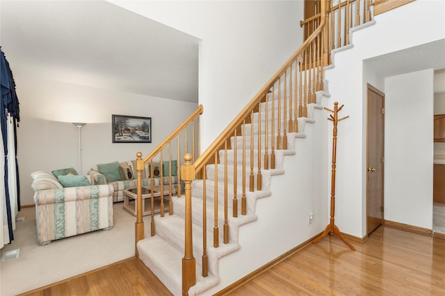 9040 Telford Cir, Johnston, IA 50131 - stairs featuring wood finished floors and baseboards