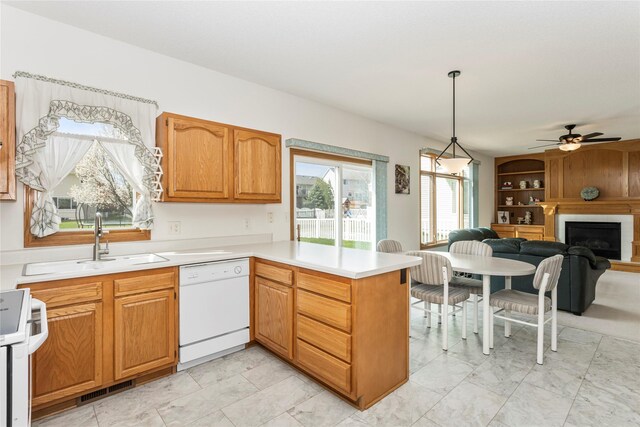 9040 Telford Cir, Johnston, IA 50131 - kitchen featuring white appliances, a peninsula, open floor plan, a sink, and light countertops