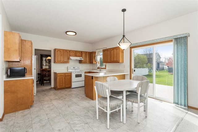 9040 Telford Cir, Johnston, IA 50131 - kitchen featuring white appliances, under cabinet range hood, light countertops, brown cabinets, and pendant lighting