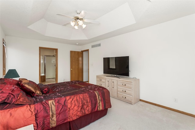 9040 Telford Cir, Johnston, IA 50131 - bedroom with a tray ceiling, light carpet, baseboards, ensuite bathroom, and a ceiling fan