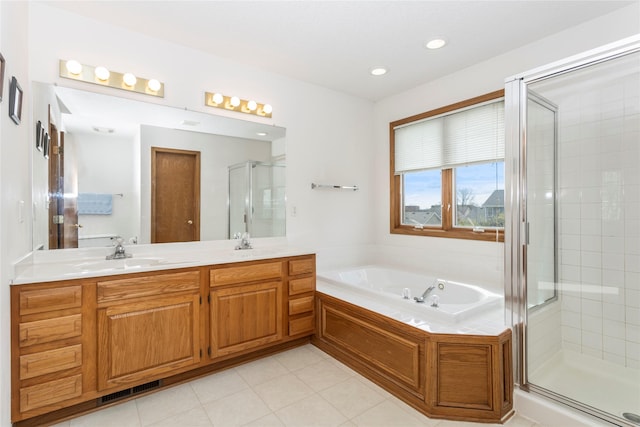 9040 Telford Cir, Johnston, IA 50131 - full bath featuring a shower stall, a bath, double vanity, tile patterned flooring, and recessed lighting