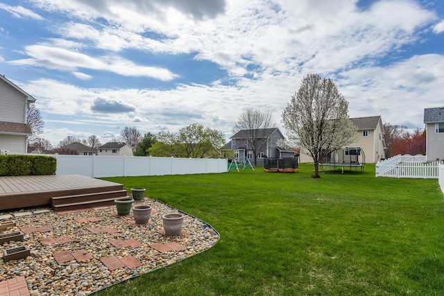 9040 Telford Cir, Johnston, IA 50131 - view of yard with a trampoline, a deck, and a playground