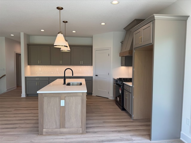 1112 2nd St NE, Altoona, IA 50009 - kitchen with black gas range oven, a sink, gray cabinets, a center island with sink, and recessed lighting