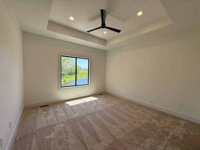 1112 2nd St NE, Altoona, IA 50009 - unfurnished room with a raised ceiling, ceiling fan, carpet flooring, baseboards, and recessed lighting