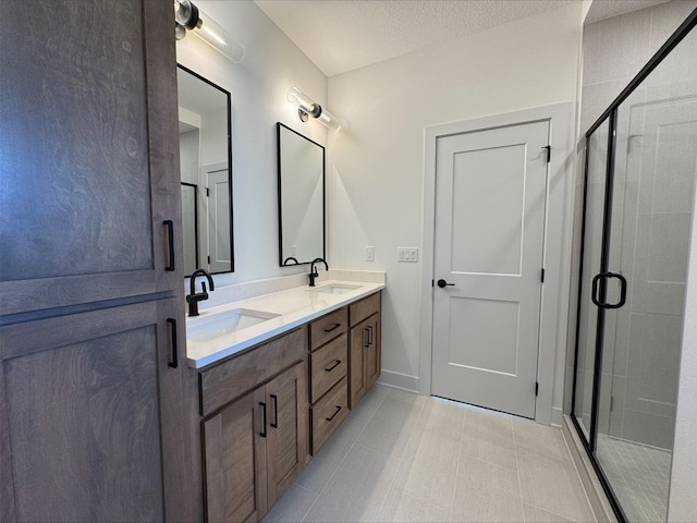 1112 2nd St NE, Altoona, IA 50009 - full bath featuring a shower stall, double vanity, tile patterned floors, and a textured ceiling