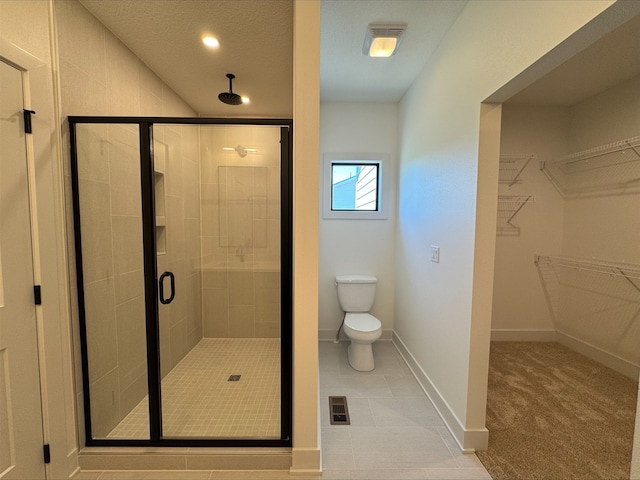 1112 2nd St NE, Altoona, IA 50009 - bathroom featuring a shower stall, toilet, baseboards, a spacious closet, and recessed lighting