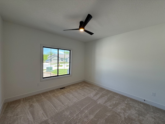 1112 2nd St NE, Altoona, IA 50009 - spare room with light colored carpet, ceiling fan, a textured ceiling, and baseboards