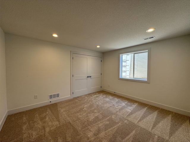 1112 2nd St NE, Altoona, IA 50009 - unfurnished bedroom with carpet flooring, recessed lighting, baseboards, a textured ceiling, and a closet