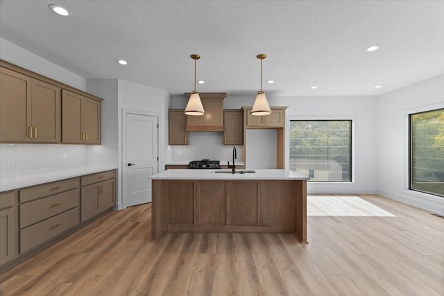 1112 2nd St NE, Altoona, IA 50009 - kitchen with light wood-type flooring, a center island with sink, a sink, plenty of natural light, and recessed lighting