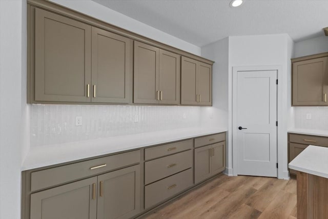 1112 2nd St NE, Altoona, IA 50009 - kitchen with light wood-type flooring, backsplash, and light countertops