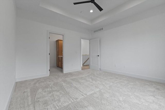 1112 2nd St NE, Altoona, IA 50009 - unfurnished bedroom with carpet floors, a raised ceiling, recessed lighting, and baseboards