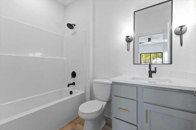 1112 2nd St NE, Altoona, IA 50009 - bathroom with wood finished floors, vanity, toilet, and bathing tub / shower combination
