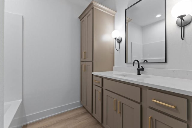1112 2nd St NE, Altoona, IA 50009 - bathroom with wood finished floors, vanity, and baseboards