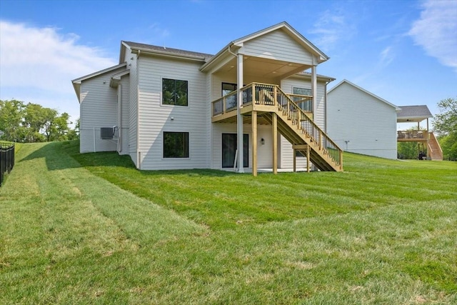 1112 2nd St NE, Altoona, IA 50009 - rear view of house featuring stairway, a deck, and a lawn
