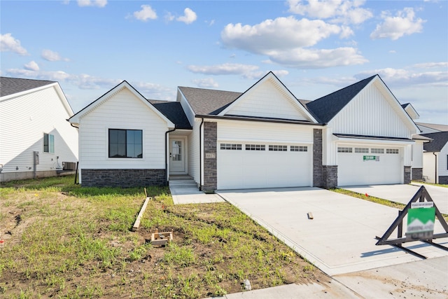 4413 NW Olivia Ln, Ankeny, IA 50023 - view of front of house with an attached garage, concrete driveway, board and batten siding, and stone siding