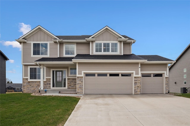 70 NW Hidden Knl, Waukee, IA 50263 - craftsman-style home featuring board and batten siding, driveway, a front lawn, and stone siding