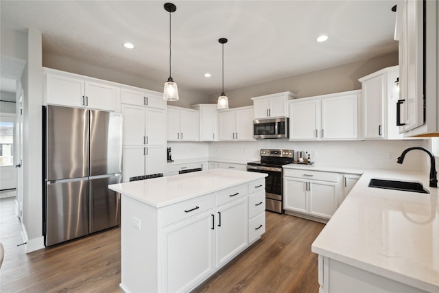 70 NW Hidden Knl, Waukee, IA 50263 - kitchen with appliances with stainless steel finishes, a sink, tasteful backsplash, a center island, and recessed lighting
