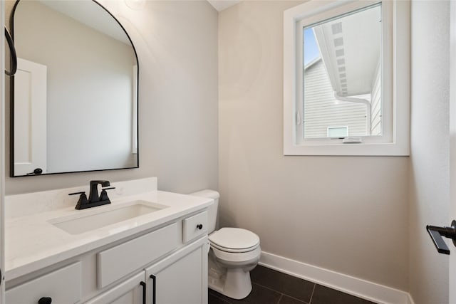 70 NW Hidden Knl, Waukee, IA 50263 - bathroom featuring toilet, baseboards, vanity, and tile patterned flooring