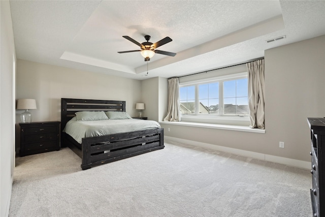 70 NW Hidden Knl, Waukee, IA 50263 - carpeted bedroom with a tray ceiling, baseboards, a textured ceiling, and a ceiling fan