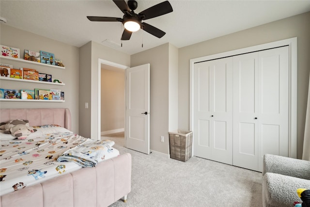 70 NW Hidden Knl, Waukee, IA 50263 - bedroom featuring carpet flooring, a closet, ceiling fan, and baseboards