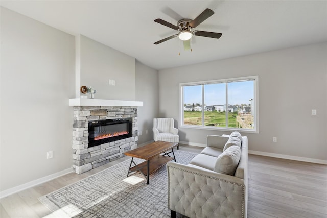 1715 Willow Ct, Norwalk, IA 50211 - living room with ceiling fan, baseboards, wood finished floors, and a fireplace