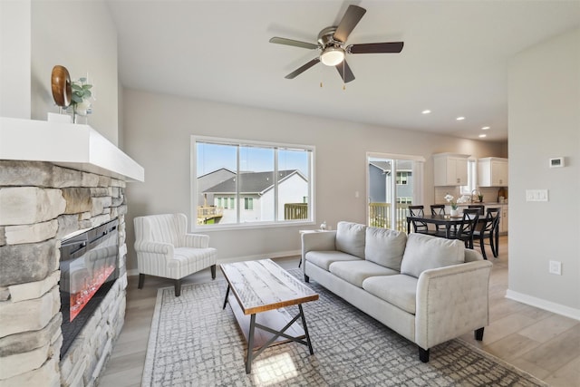 1715 Willow Ct, Norwalk, IA 50211 - living area with a wealth of natural light, light wood-style flooring, a fireplace, and ceiling fan