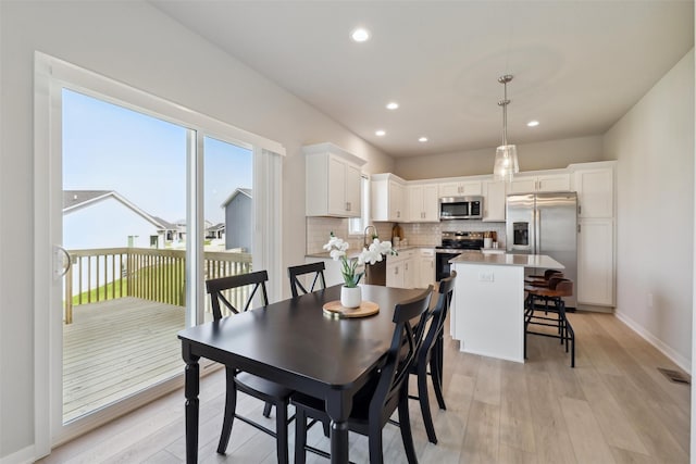 1715 Willow Ct, Norwalk, IA 50211 - dining room with baseboards, recessed lighting, visible vents, and light wood-type flooring