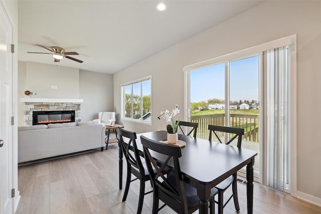 1715 Willow Ct, Norwalk, IA 50211 - dining area featuring recessed lighting, a ceiling fan, light wood-style floors, baseboards, and a fireplace