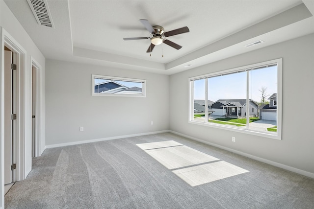 1715 Willow Ct, Norwalk, IA 50211 - unfurnished bedroom with baseboards, carpet floors, visible vents, and a raised ceiling