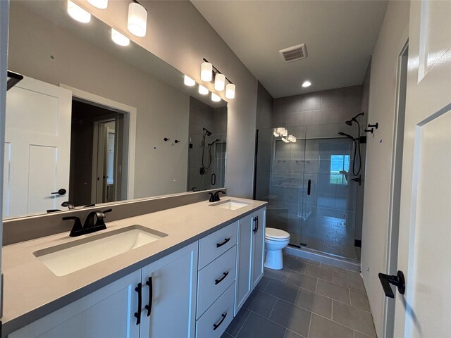 1910 Silver Maple Dr, Norwalk, IA 50211 - full bath featuring tile patterned flooring, a stall shower, double vanity, toilet, and recessed lighting