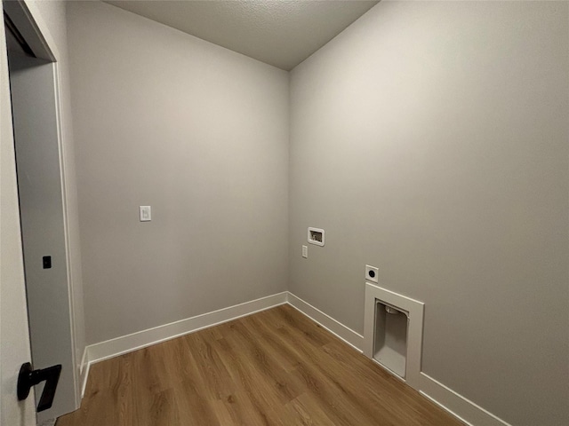 1910 Silver Maple Dr, Norwalk, IA 50211 - laundry area with electric dryer hookup, hookup for a washing machine, light wood-type flooring, and baseboards