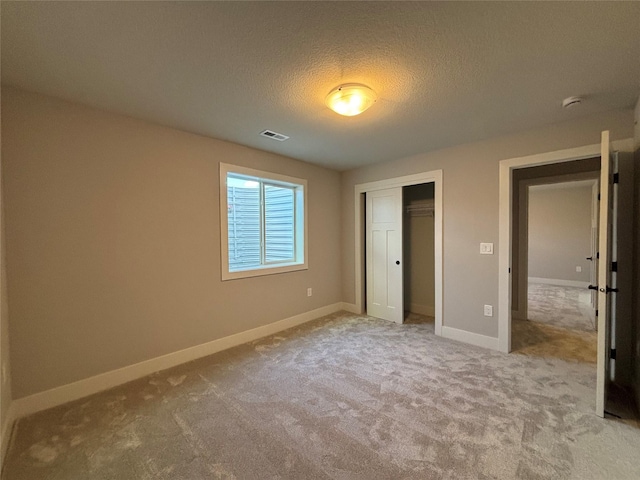 1910 Silver Maple Dr, Norwalk, IA 50211 - unfurnished bedroom with carpet floors, a closet, a textured ceiling, and baseboards