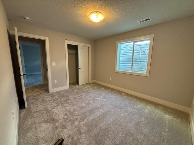 1910 Silver Maple Dr, Norwalk, IA 50211 - unfurnished bedroom featuring carpet floors, a closet, a textured ceiling, and baseboards