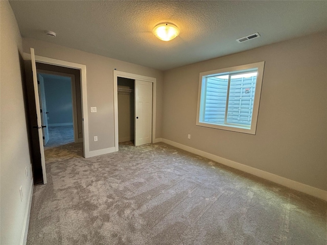 1910 Silver Maple Dr, Norwalk, IA 50211 - unfurnished bedroom featuring carpet, a closet, a textured ceiling, and baseboards