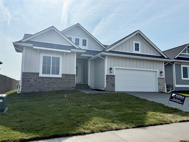 1910 Silver Maple Dr, Norwalk, IA 50211 - craftsman-style home featuring board and batten siding, stone siding, driveway, and a front yard