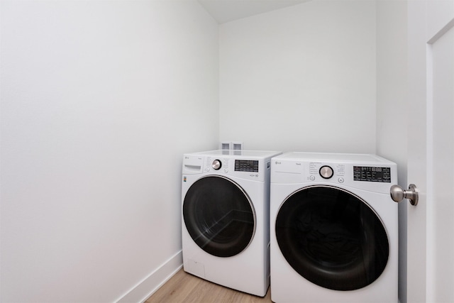 4125 NE 6th St, Ankeny, IA 50021 - washroom with washer and dryer, laundry area, baseboards, and light wood-style flooring