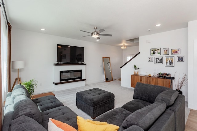 4125 NE 6th St, Ankeny, IA 50021 - living area featuring a glass covered fireplace, recessed lighting, baseboards, and ceiling fan