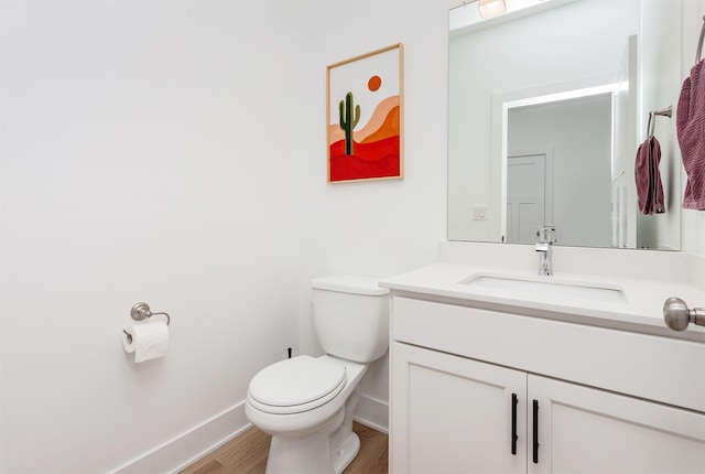 4125 NE 6th St, Ankeny, IA 50021 - half bathroom with toilet, wood finished floors, vanity, and baseboards
