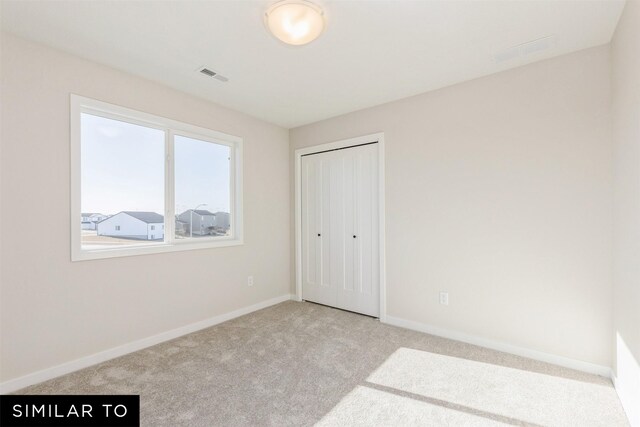 6511 NE George Ave, Pleasant Hill, IA 50327 - unfurnished bedroom featuring carpet, baseboards, and a closet