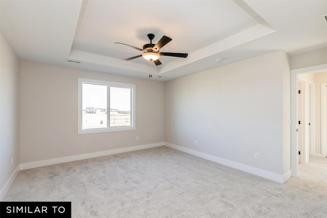6511 NE George Ave, Pleasant Hill, IA 50327 - carpeted spare room featuring a raised ceiling, ceiling fan, and baseboards