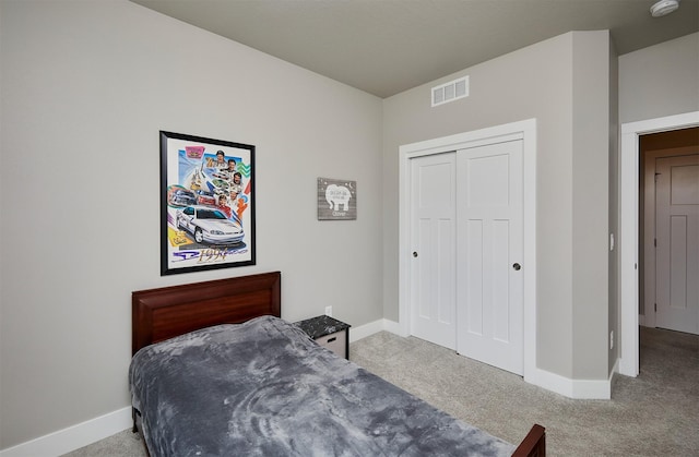 carpeted bedroom featuring a closet, baseboards, and visible vents
