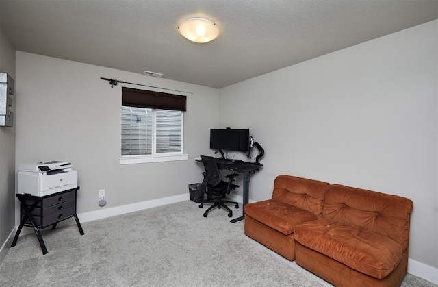 office area featuring carpet flooring, visible vents, and baseboards