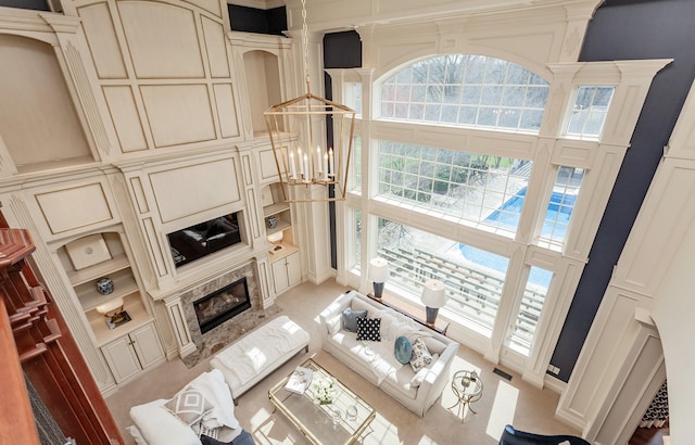 7580 NW 100th St, Johnston, IA 50131 - living area with a high ceiling, a premium fireplace, and built in shelves